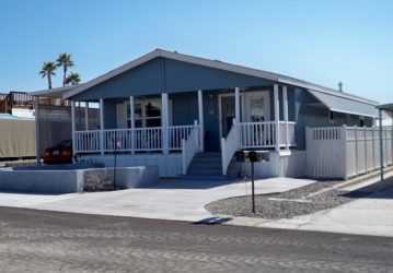 mobile home with railings and window awnings