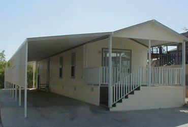 another view of mobile home with carport